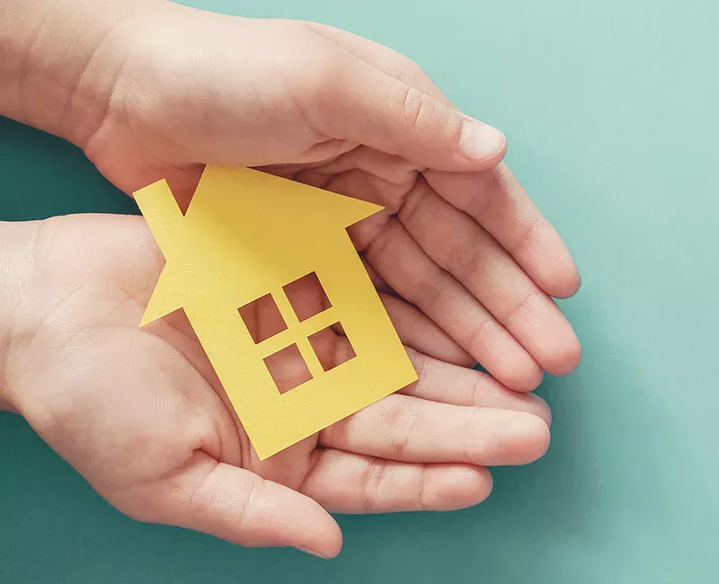 Hands holding paper home